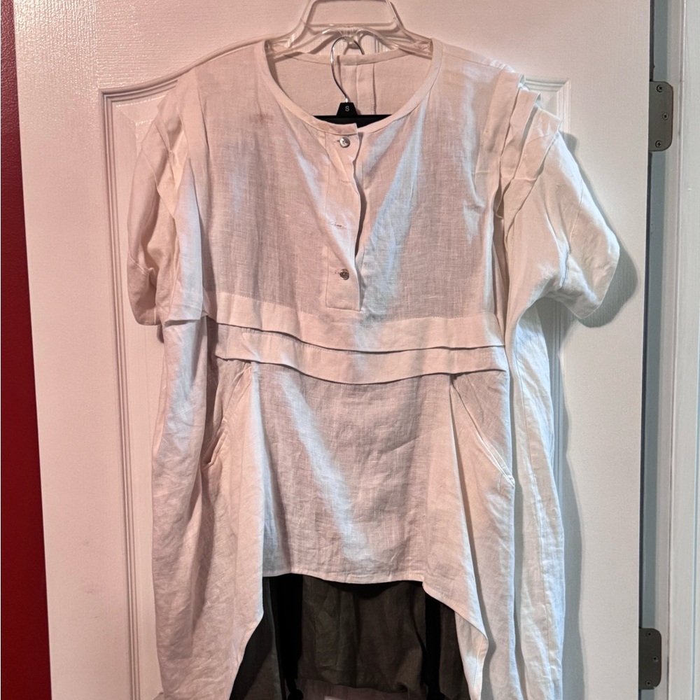 Large oversized shirt worn once stylish and unusual. Short geometrical in back.